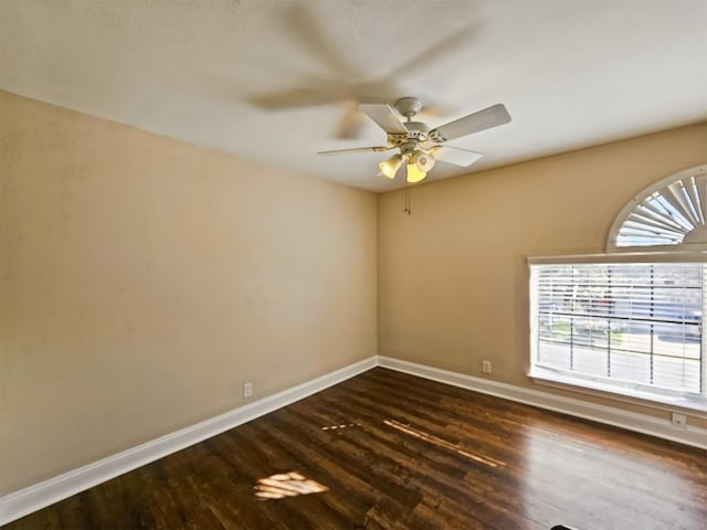 spare room featuring dark hardwood / wood-style floors and ceiling fan