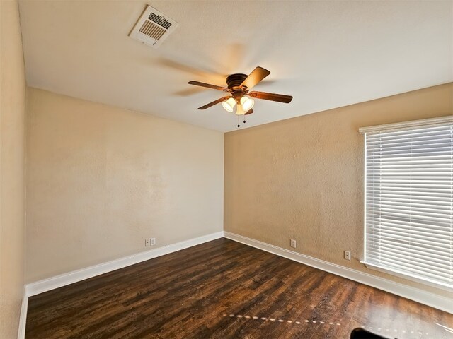 unfurnished room with dark hardwood / wood-style floors and ceiling fan