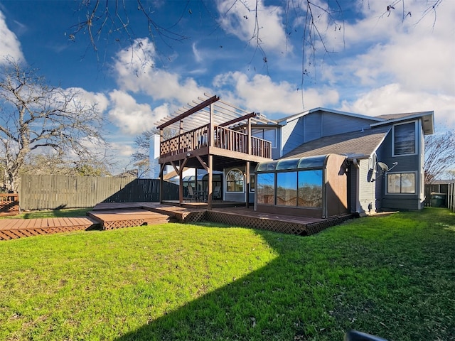 back of house with a wooden deck, a sunroom, a lawn, and a pergola