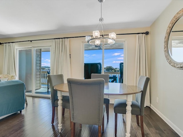 dining area featuring plenty of natural light, dark wood-type flooring, and a chandelier