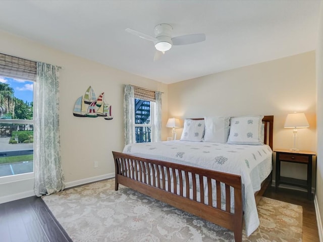 bedroom featuring multiple windows, ceiling fan, and light hardwood / wood-style flooring