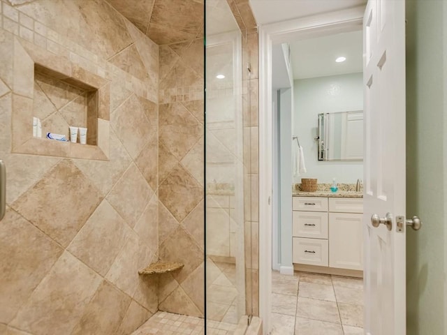 bathroom featuring tile patterned floors, vanity, and an enclosed shower