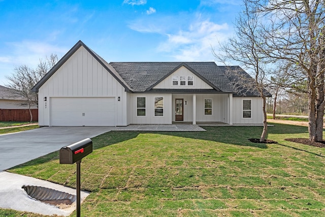 modern inspired farmhouse featuring a front yard and a garage