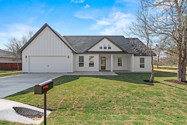 modern inspired farmhouse featuring a garage, a front lawn, and a porch