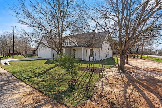 view of front of property with a garage and a front lawn