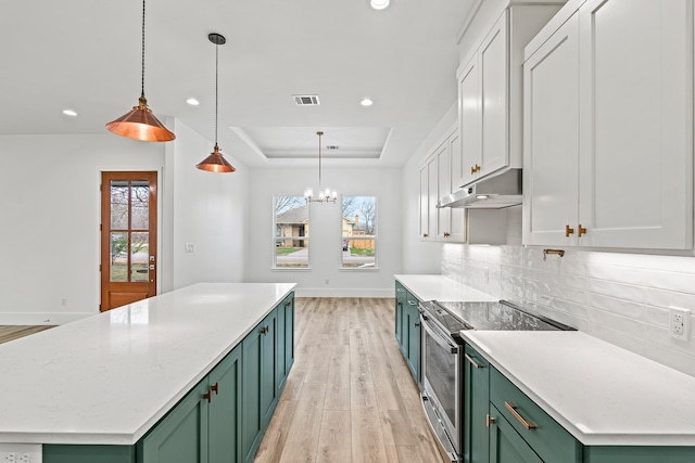 kitchen featuring white cabinets, decorative light fixtures, stainless steel electric stove, and green cabinets