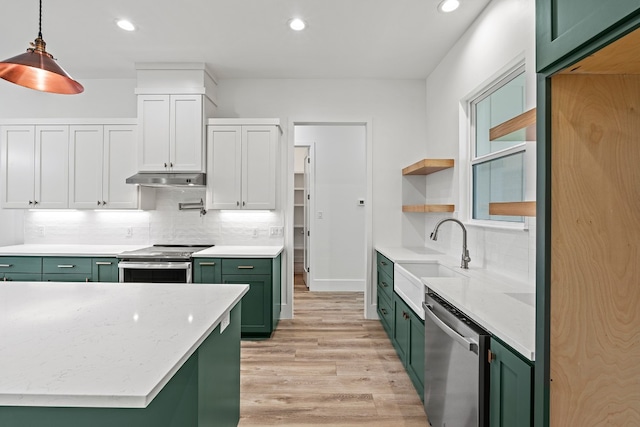 kitchen with white cabinetry, sink, hanging light fixtures, stainless steel appliances, and green cabinets