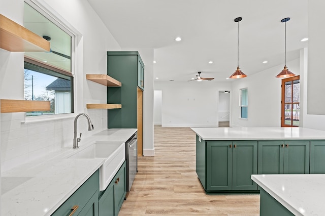 kitchen featuring ceiling fan, dishwasher, light hardwood / wood-style floors, hanging light fixtures, and green cabinets