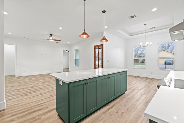 kitchen featuring green cabinets, light hardwood / wood-style flooring, hanging light fixtures, and ceiling fan with notable chandelier