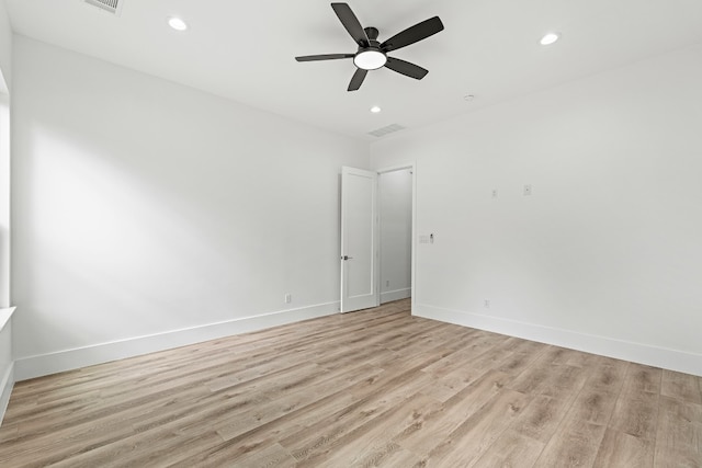 spare room featuring ceiling fan and light hardwood / wood-style flooring