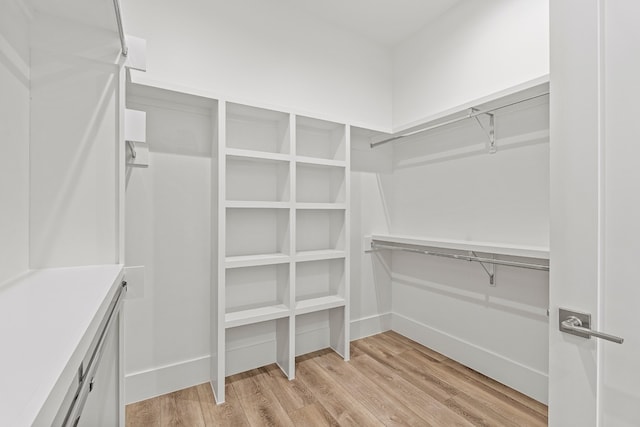 walk in closet with light wood-type flooring