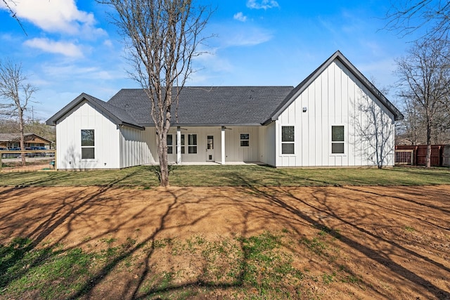 rear view of property with a patio area, ceiling fan, and a yard