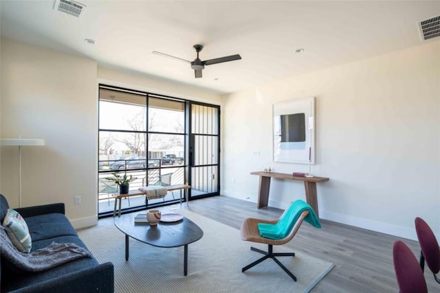 living room with ceiling fan, hardwood / wood-style floors, and a baseboard radiator