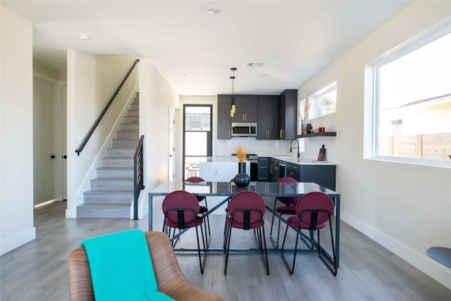 dining room with sink and dark wood-type flooring