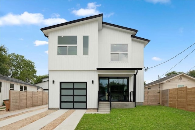 rear view of property with a yard and a garage