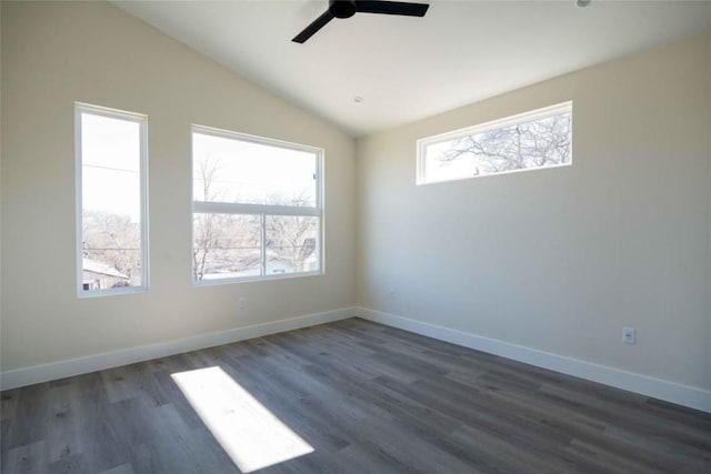 spare room featuring ceiling fan, a healthy amount of sunlight, dark hardwood / wood-style flooring, and lofted ceiling