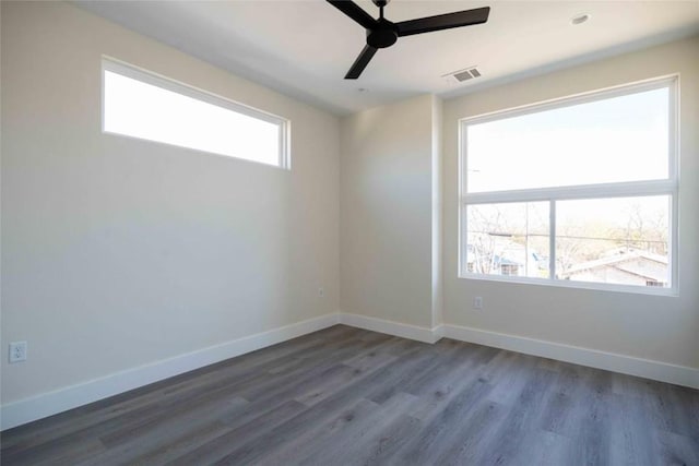 unfurnished room featuring ceiling fan and dark wood-type flooring