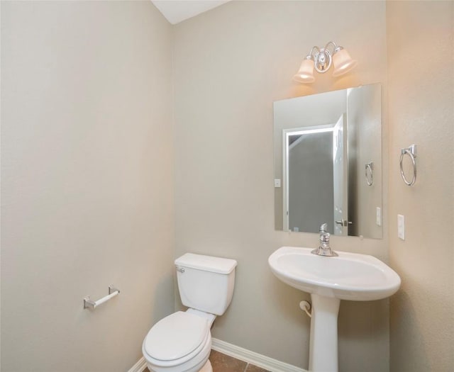 bathroom featuring tile patterned flooring and toilet