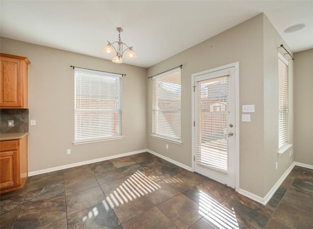 unfurnished dining area with a chandelier