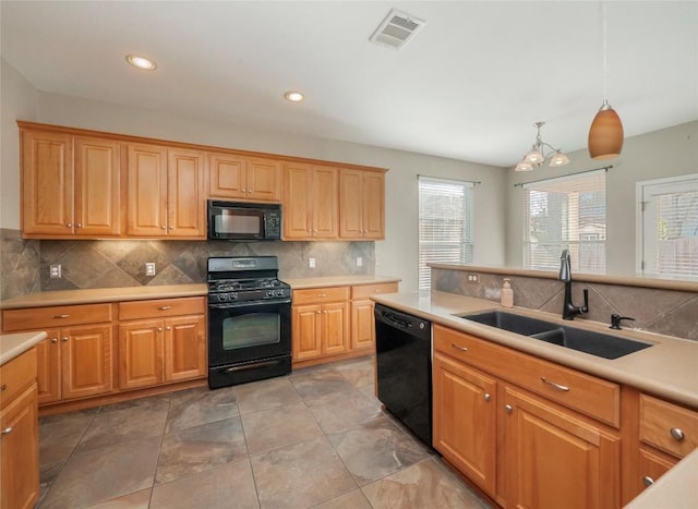 kitchen with backsplash, sink, black appliances, a notable chandelier, and hanging light fixtures