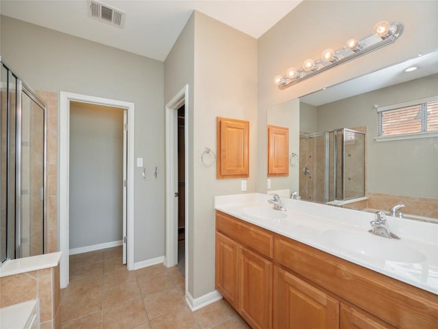 bathroom with tile patterned flooring, shower with separate bathtub, and vanity