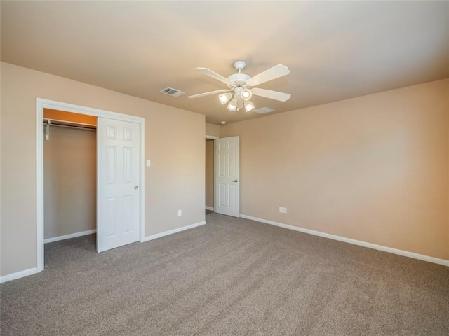 unfurnished bedroom with carpet floors, a closet, and ceiling fan