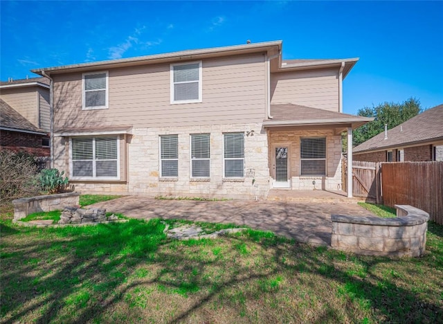 rear view of property featuring a lawn and a patio area