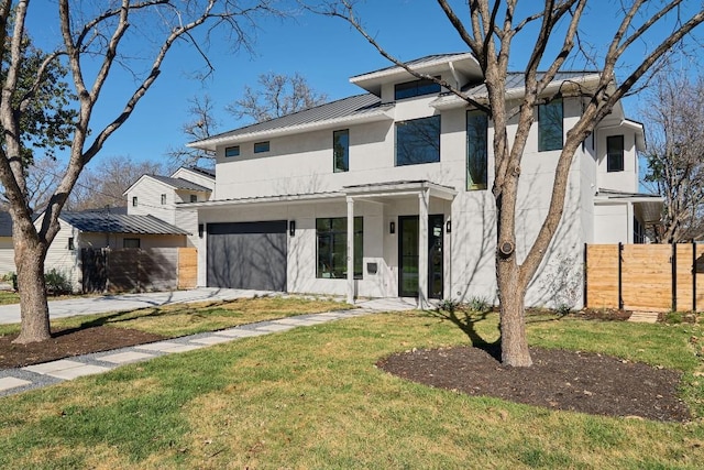 view of front of house featuring a garage and a front yard