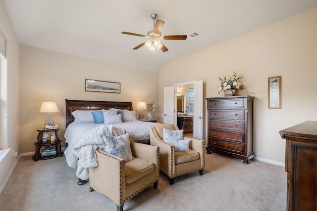 carpeted bedroom with ceiling fan, ensuite bath, and lofted ceiling