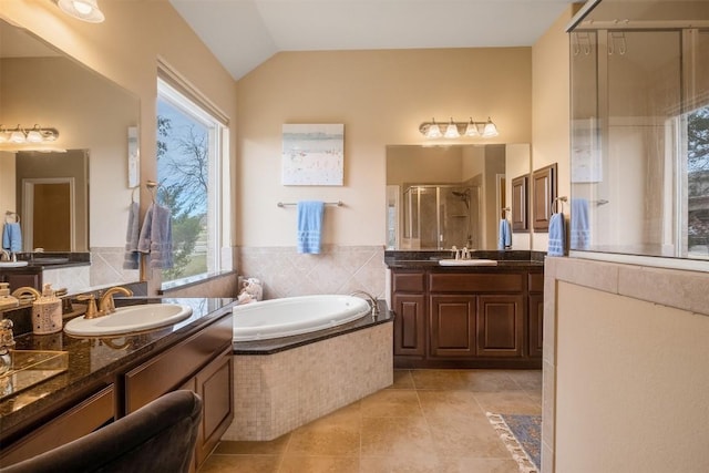 bathroom with vanity, tile patterned flooring, vaulted ceiling, and plus walk in shower