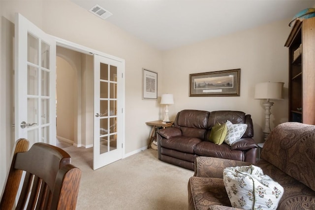 carpeted living room featuring french doors