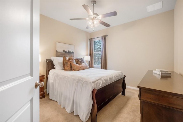 bedroom featuring ceiling fan and light carpet