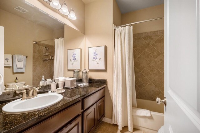 full bathroom with shower / tub combo, tile patterned flooring, vanity, and toilet