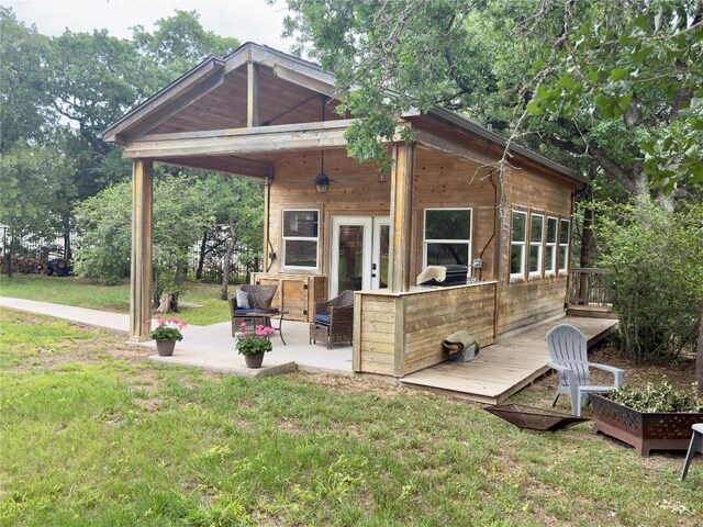 rear view of house featuring a patio area and a yard