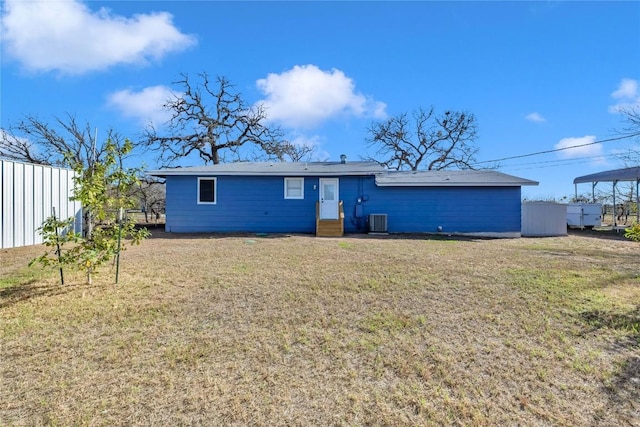 back of property with a lawn and central AC unit