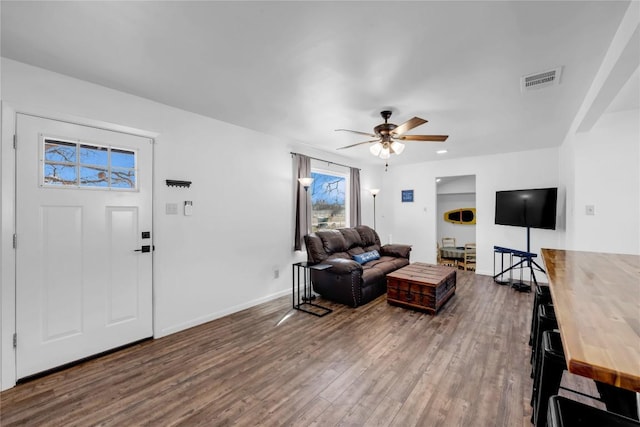 living room featuring hardwood / wood-style floors and ceiling fan