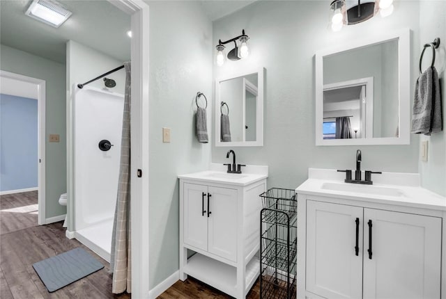 bathroom with a shower, vanity, and hardwood / wood-style flooring