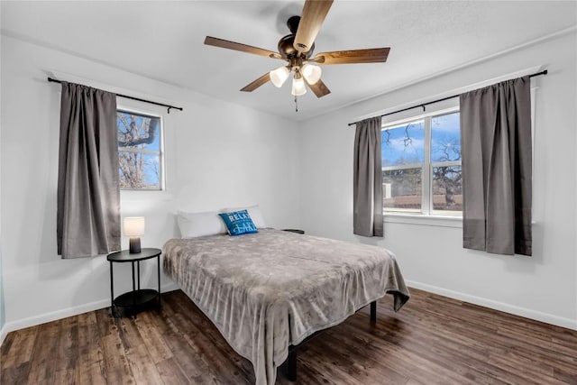 bedroom featuring dark hardwood / wood-style flooring and ceiling fan