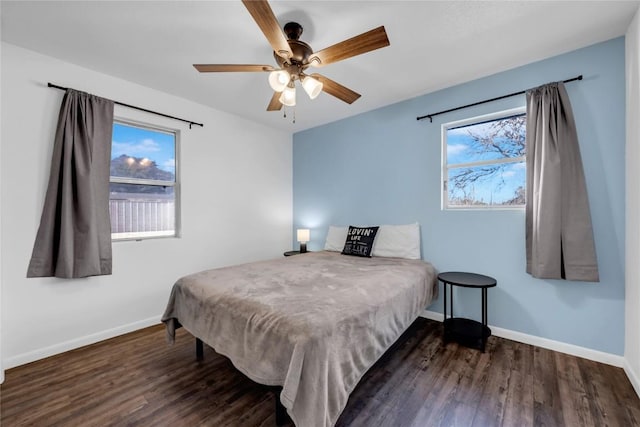 bedroom with ceiling fan and dark hardwood / wood-style floors