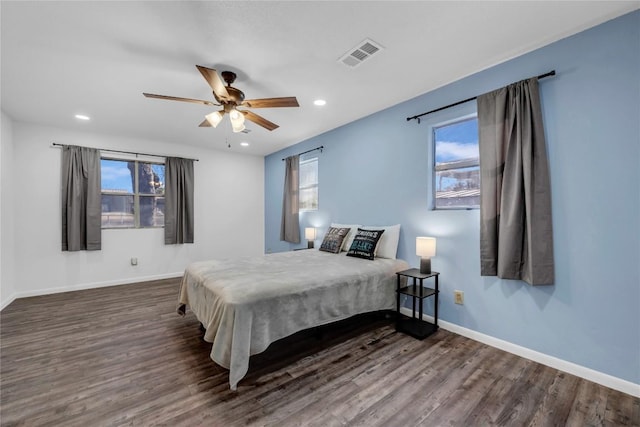 bedroom with dark hardwood / wood-style floors and ceiling fan