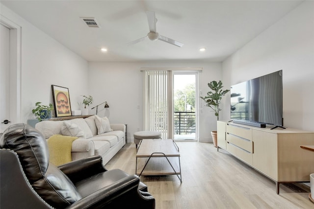 living room with ceiling fan and light hardwood / wood-style flooring