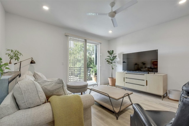 living room with light hardwood / wood-style floors and ceiling fan