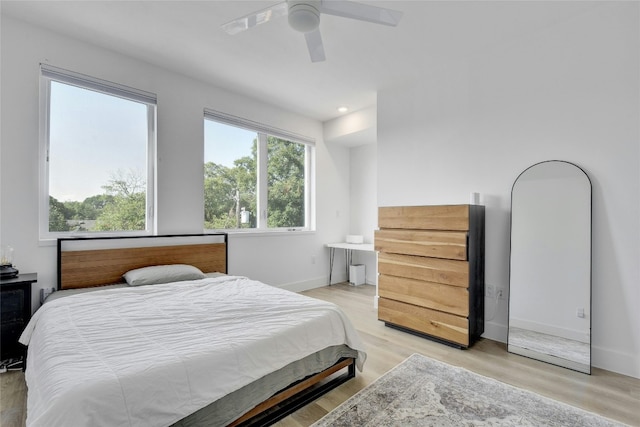 bedroom with ceiling fan and light hardwood / wood-style flooring