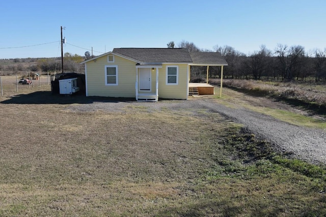 view of front of home featuring a storage unit