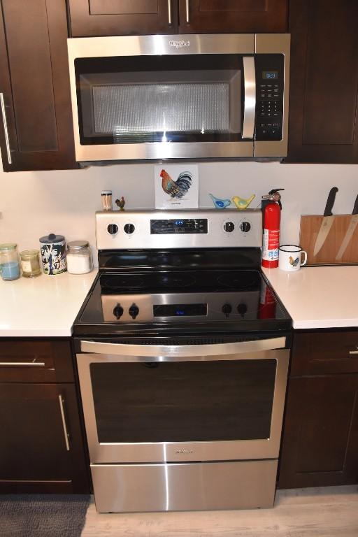 kitchen with dark brown cabinets and stainless steel appliances