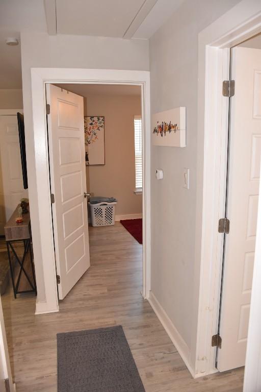 hallway with light hardwood / wood-style floors