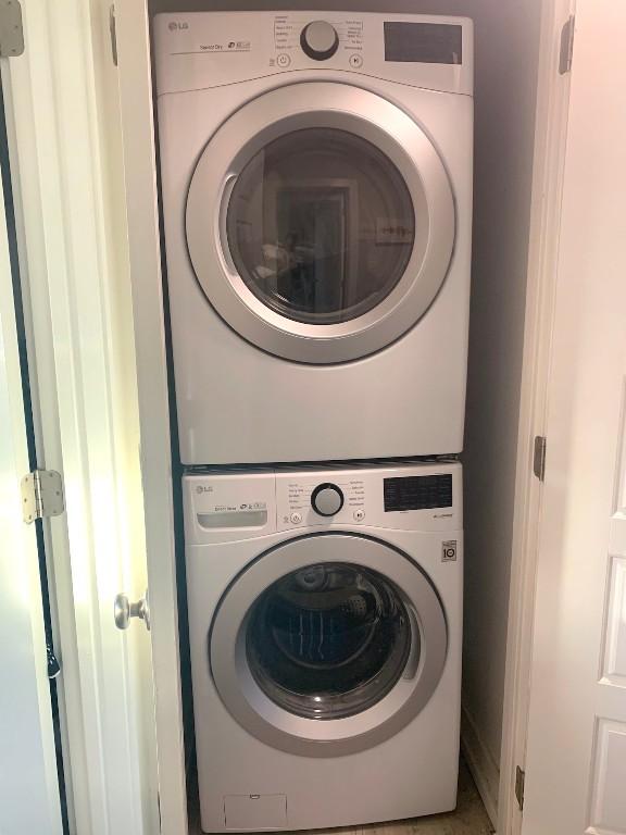 laundry area featuring stacked washer / dryer