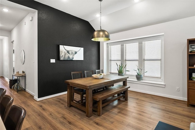 dining space featuring hardwood / wood-style flooring and lofted ceiling