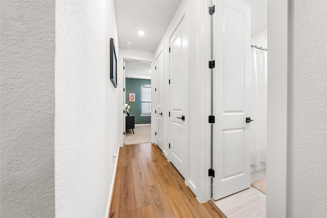 corridor with light hardwood / wood-style flooring