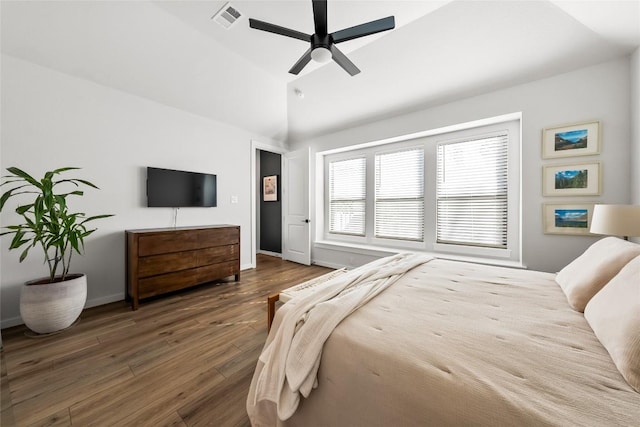 bedroom with ceiling fan, dark hardwood / wood-style floors, and lofted ceiling